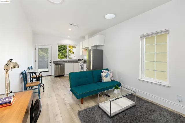 a kitchen with a refrigerator sink and cabinets