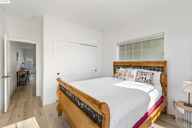 a bed sitting in a bedroom next to a window