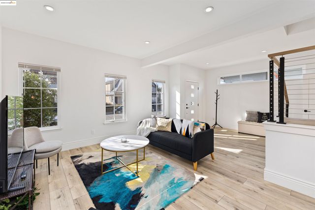 a living room with furniture a table and large window