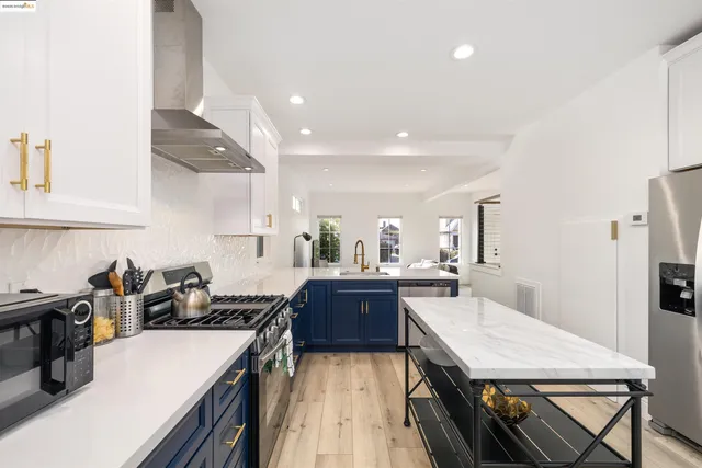 a kitchen with stainless steel appliances granite countertop sink stove and refrigerator
