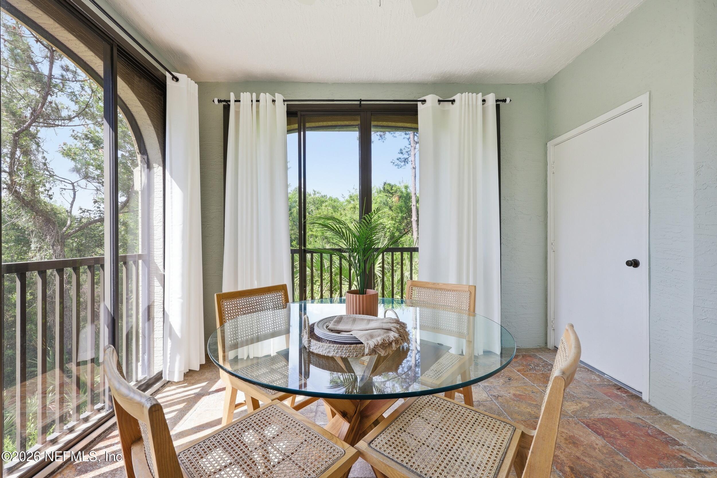 1529 Vista Cove Road St. Augustine, FL 32084 - Photo 1 of 75 a view of a dining room with furniture wooden floor and glass door