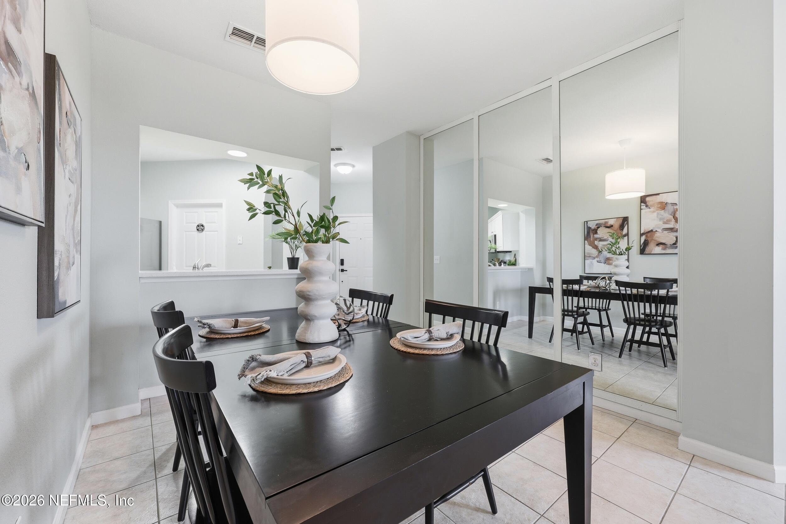 1529 Vista Cove Road St. Augustine, FL 32084 - Photo 12 of 75 a view of a dining room with furniture and chandelier