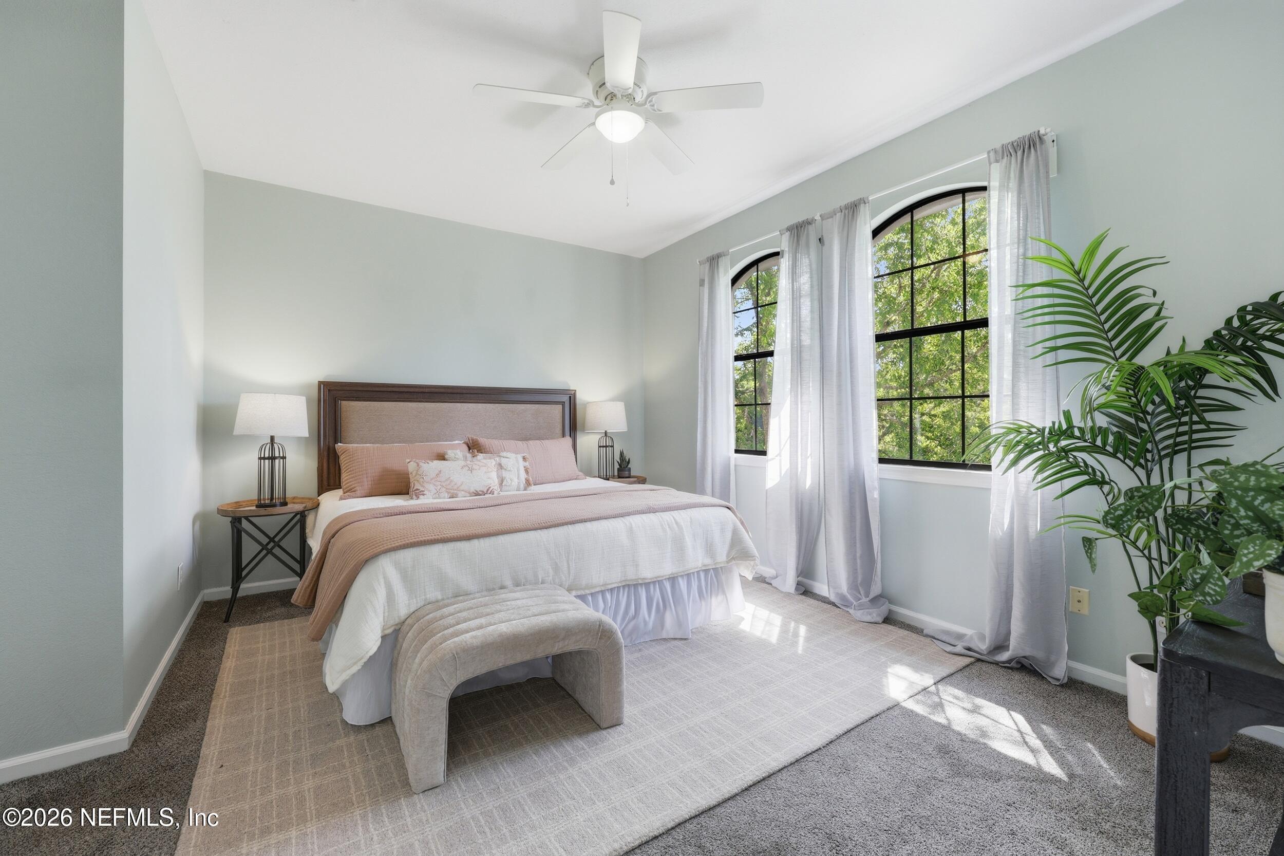 1529 Vista Cove Road St. Augustine, FL 32084 - Photo 22 of 75 a bedroom with a large bed and a potted plant