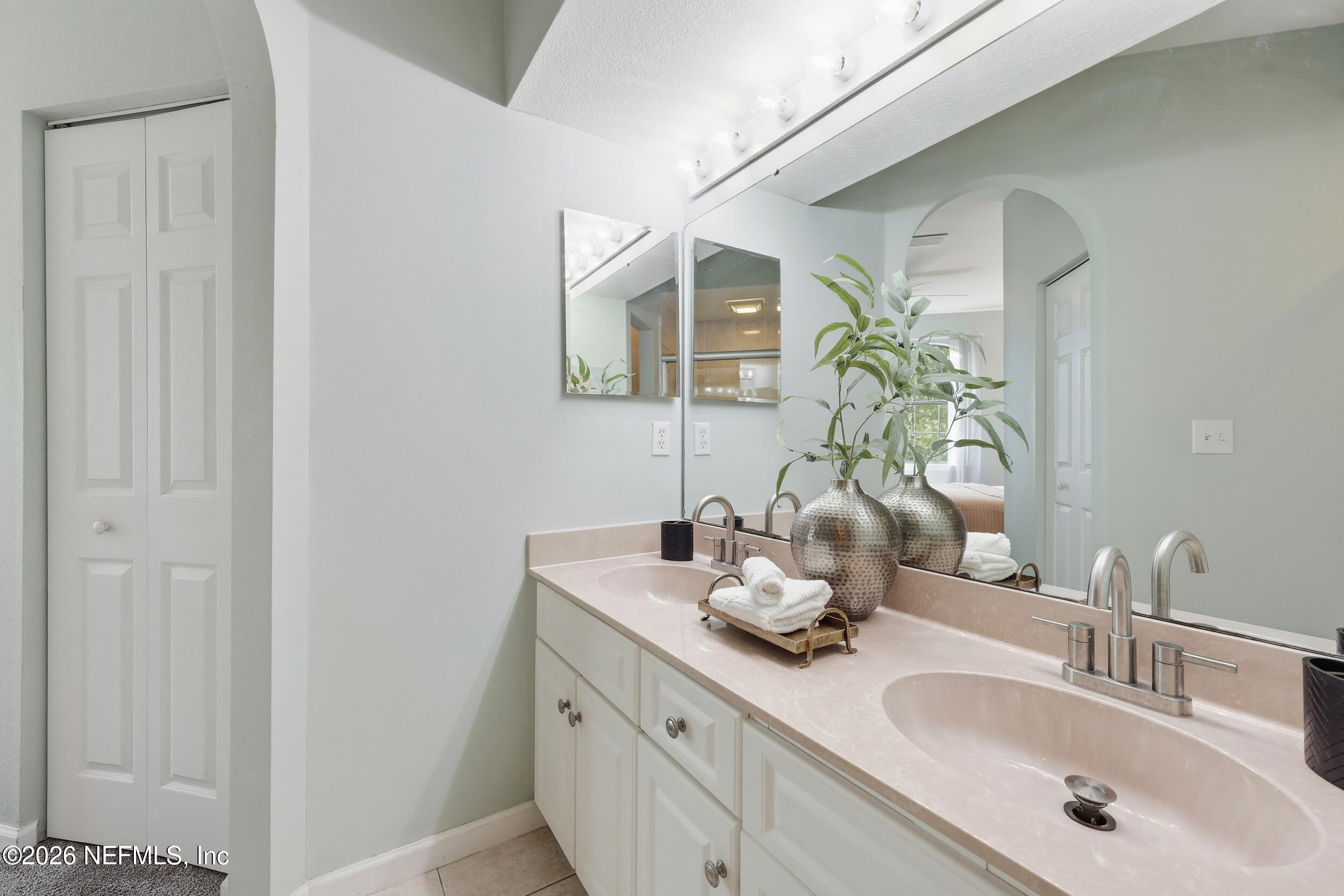 1529 Vista Cove Road St. Augustine, FL 32084 - Photo 27 of 75 a bathroom with a double vanity sink and a mirror
