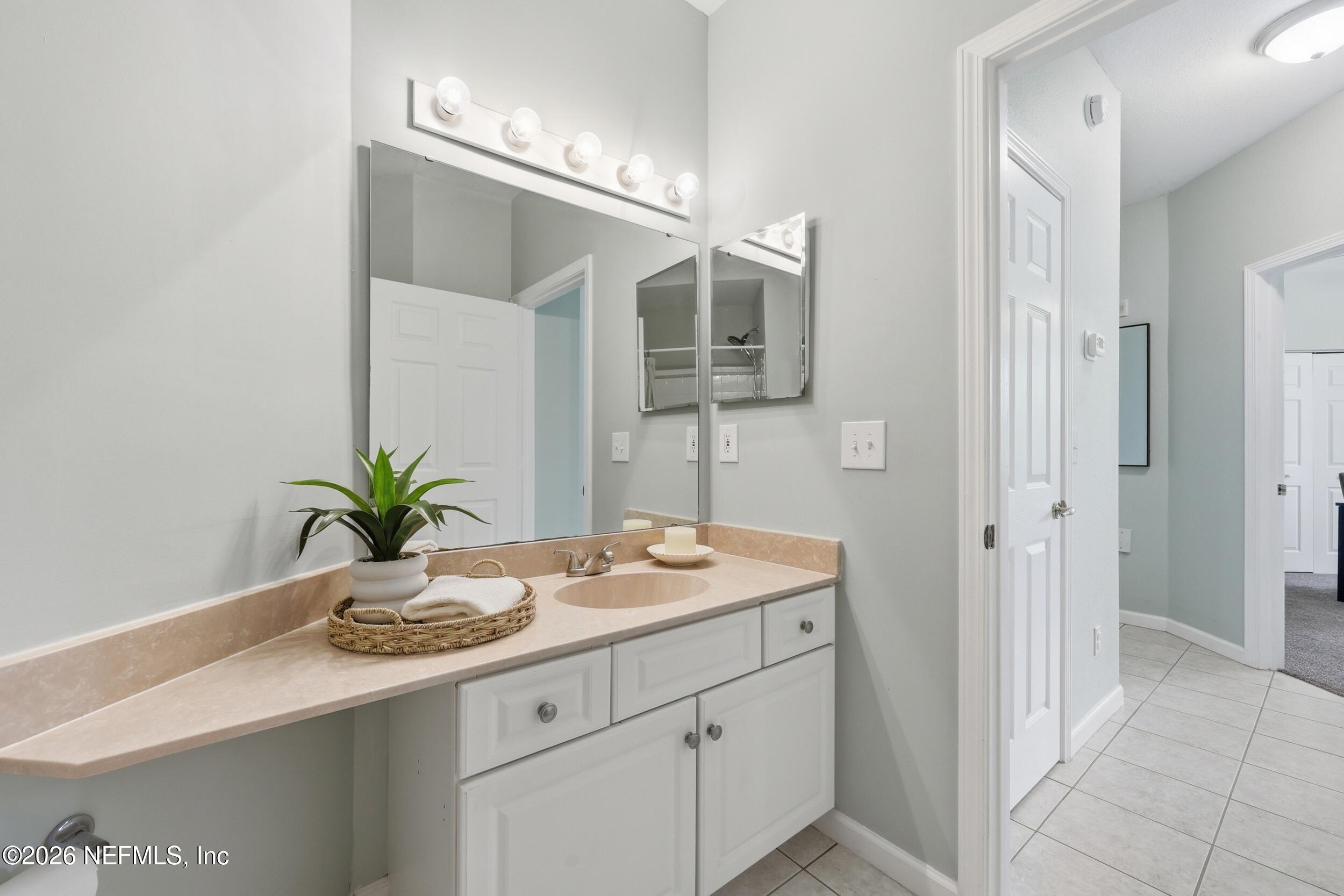 1529 Vista Cove Road St. Augustine, FL 32084 - Photo 32 of 75 a bathroom with a sink a vanity and a mirror