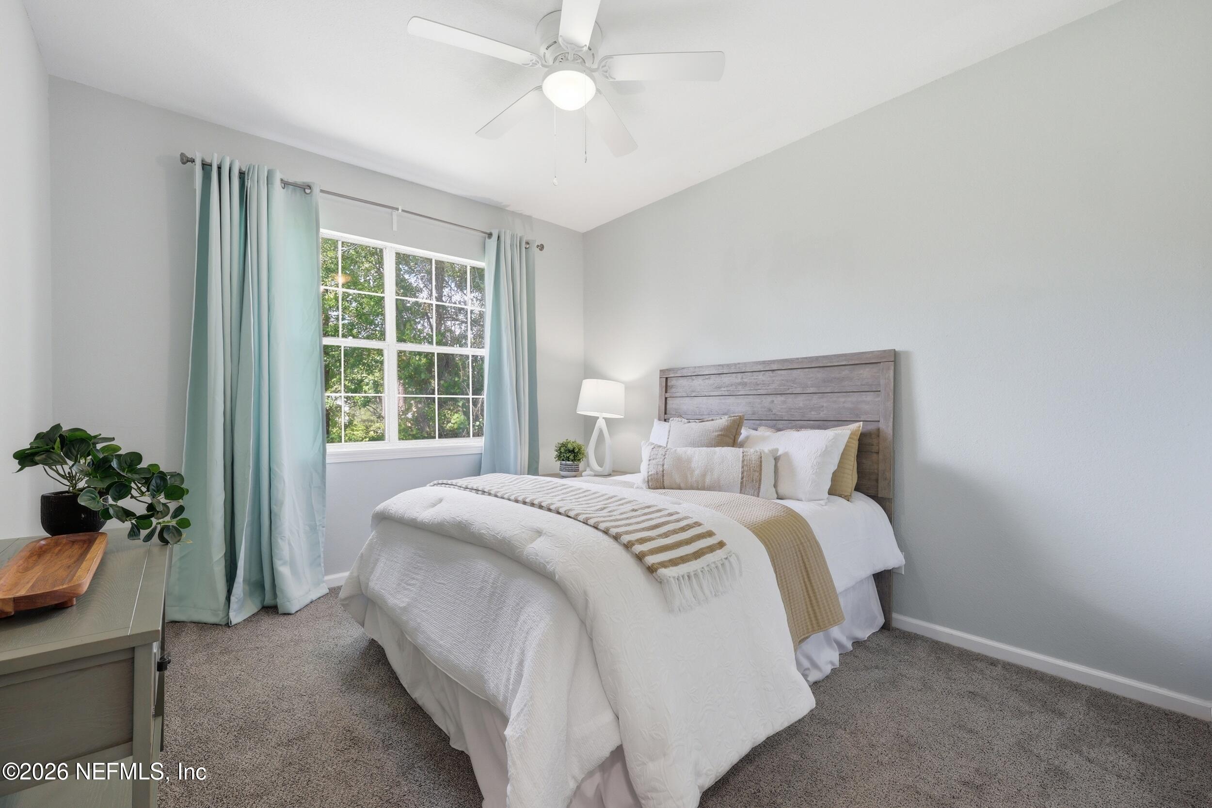 1529 Vista Cove Road St. Augustine, FL 32084 - Photo 33 of 75 a bedroom with a bed and a potted plant