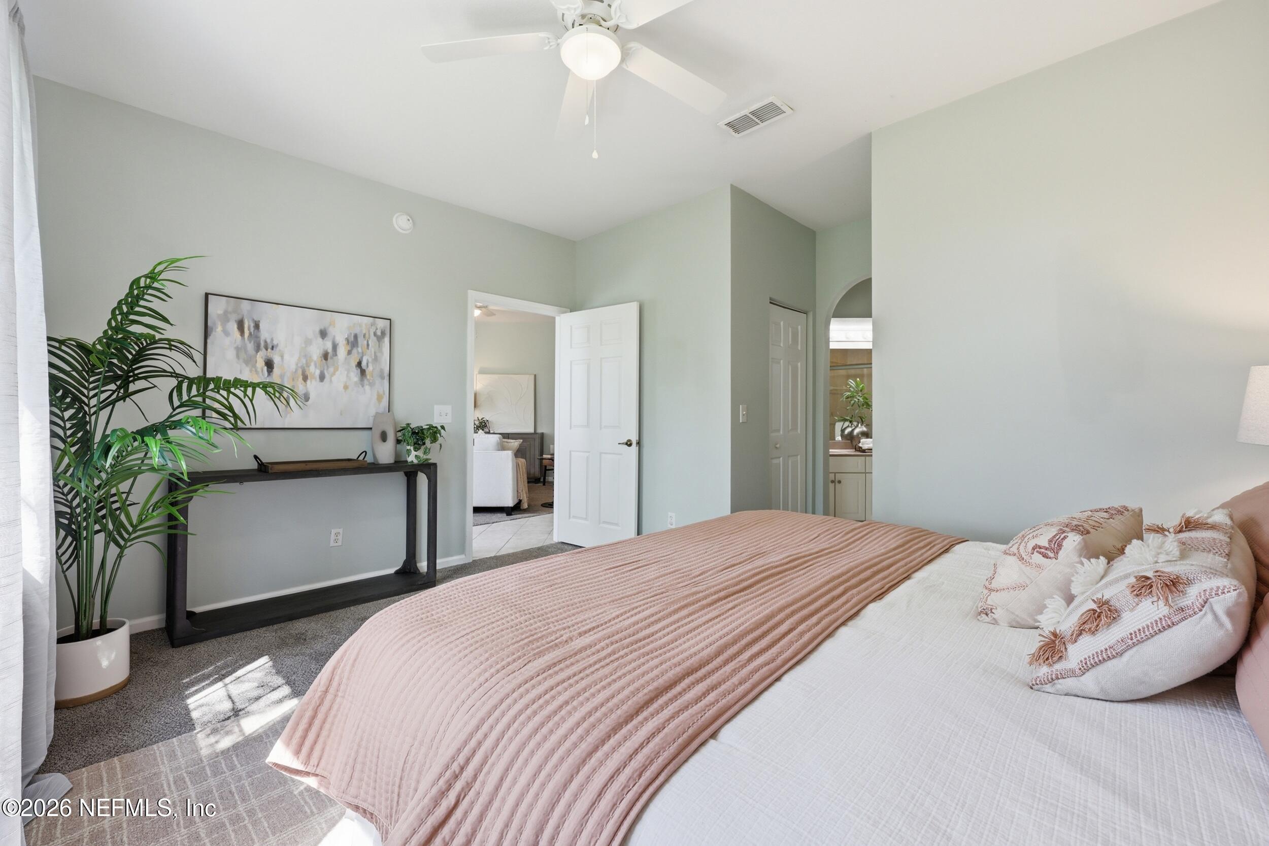 1529 Vista Cove Road St. Augustine, FL 32084 - Photo 7 of 75 a bedroom with a bed and a painting on the wall