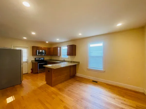 a kitchen with stainless steel appliances granite countertop a stove and a refrigerator