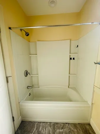 a bathroom with a bathtub and a shower