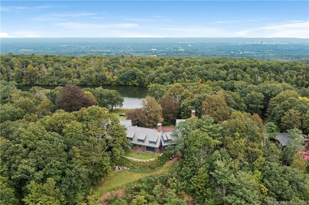 The 115-acre property includes 4 homes, 3 barns, a lake, a boathouse, a dock and floating wooden raft, and extends from Avon into Bloomfield. 90% of the land is classified as Forest Land.