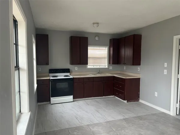a large kitchen with granite countertop stainless steel appliances and cabinets