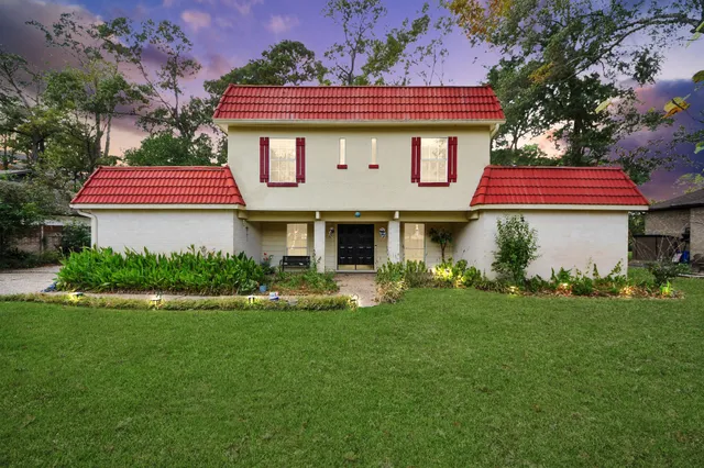 a front view of a house with a garden