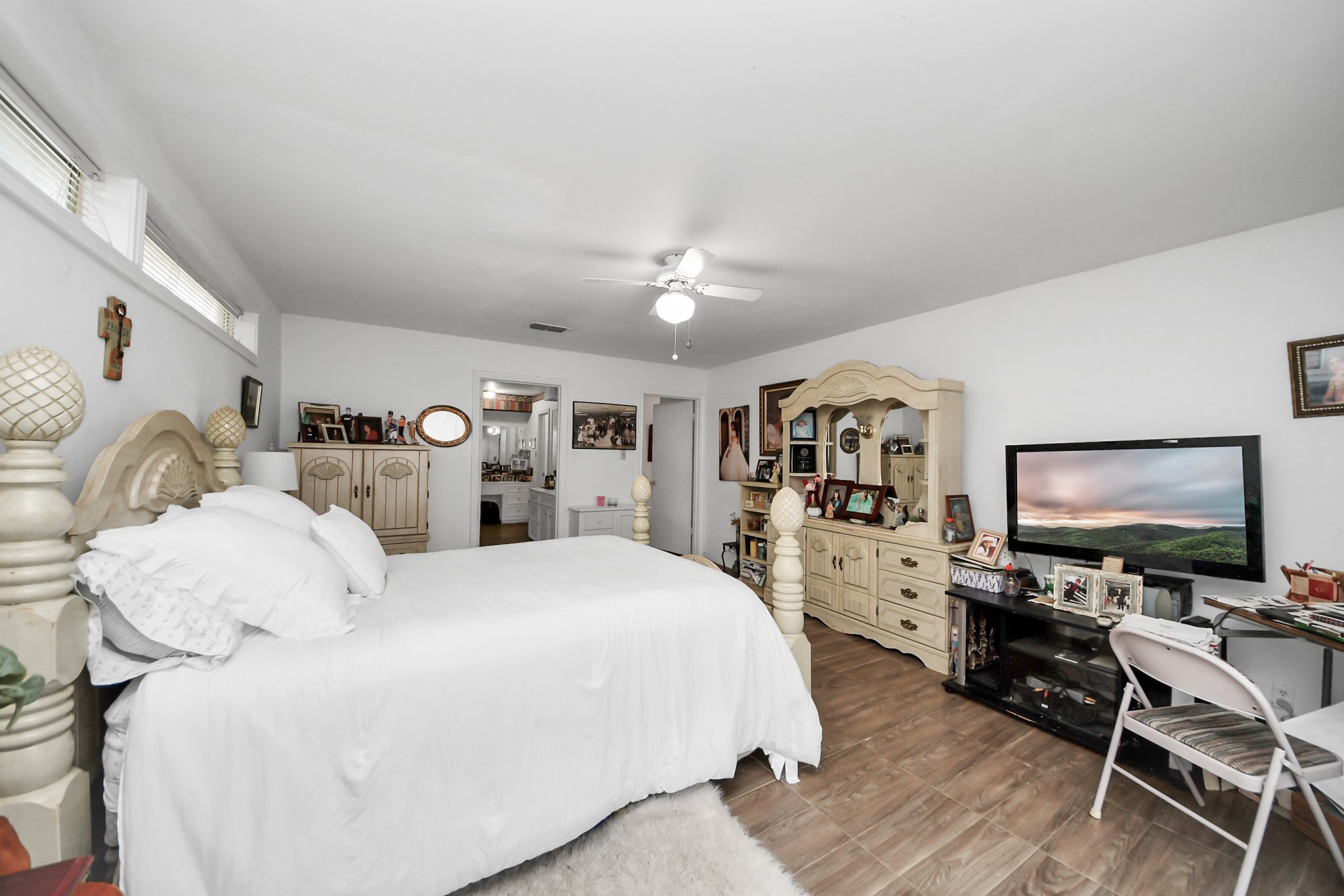 17 Winged Foot Drive Conroe, TX 77304 - Photo 27 of 46 a bedroom with a large bed and a flat tv screen on dresser