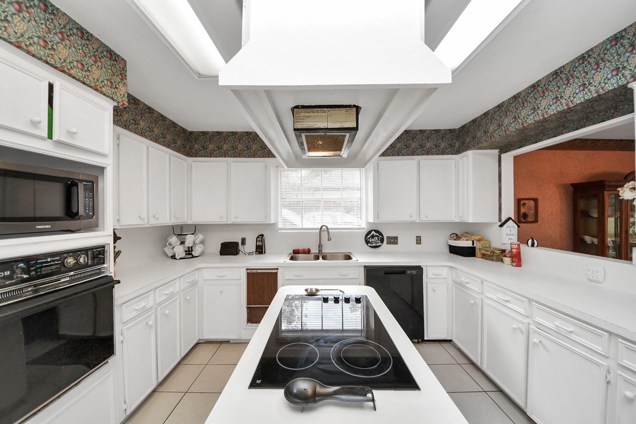 17 Winged Foot Drive Conroe, TX 77304 - Photo 33 of 46 a kitchen with a stove a sink and a microwave