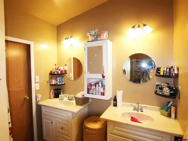a bathroom with a sink vanity mirror and toilet