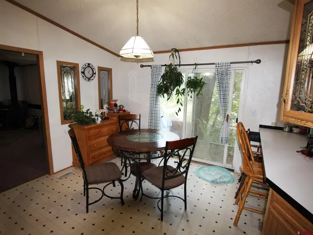 a view of a dining room with furniture and window
