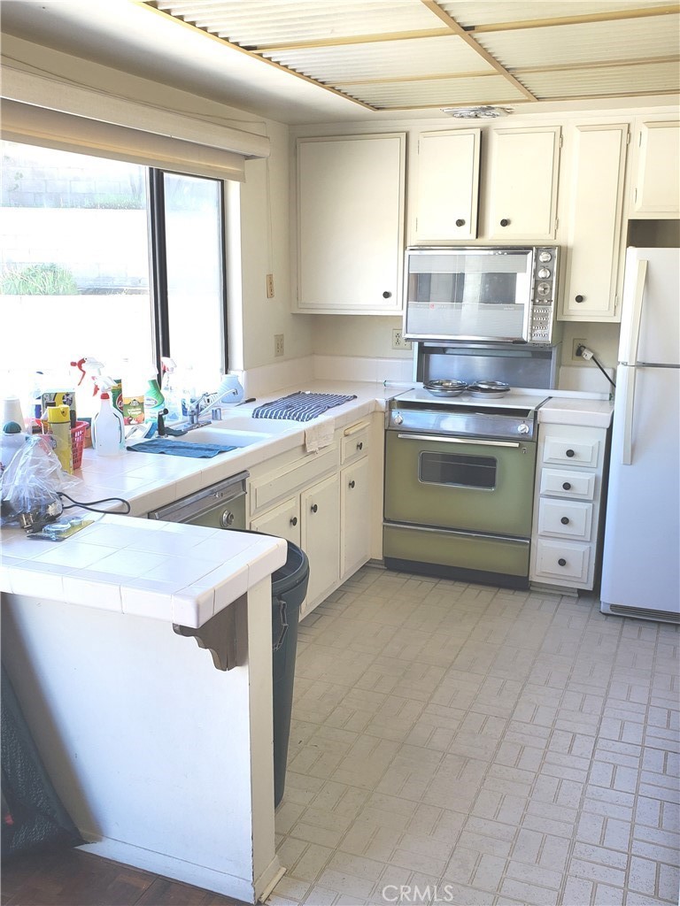 8245 Big Bear Circle Buena Park, CA 90621 - Photo 12 of 23 a kitchen with a stove a sink and a window