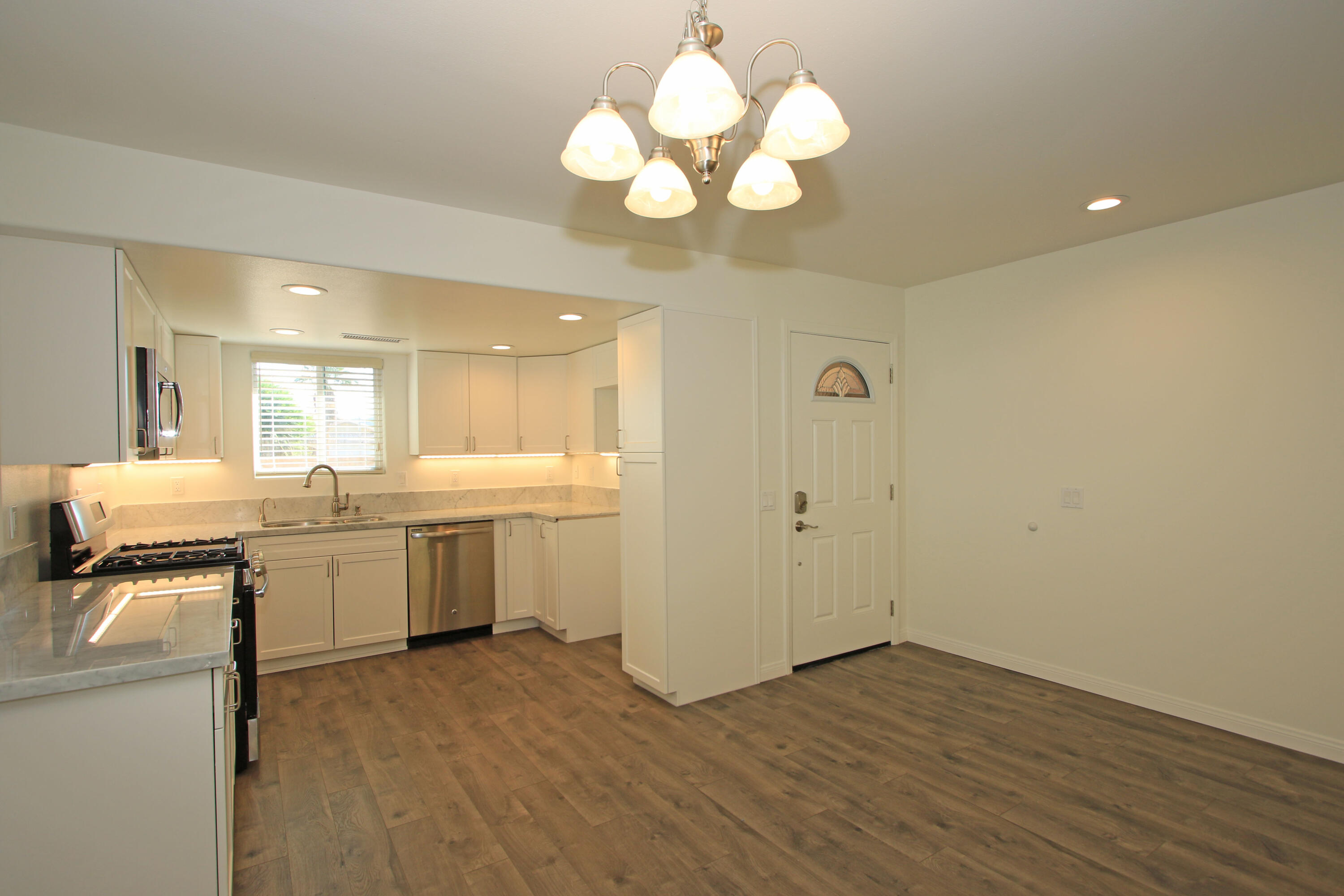 51845 Eisenhower Drive La Quinta, CA 92253 - Photo 11 of 35 a kitchen with a sink and chandelier
