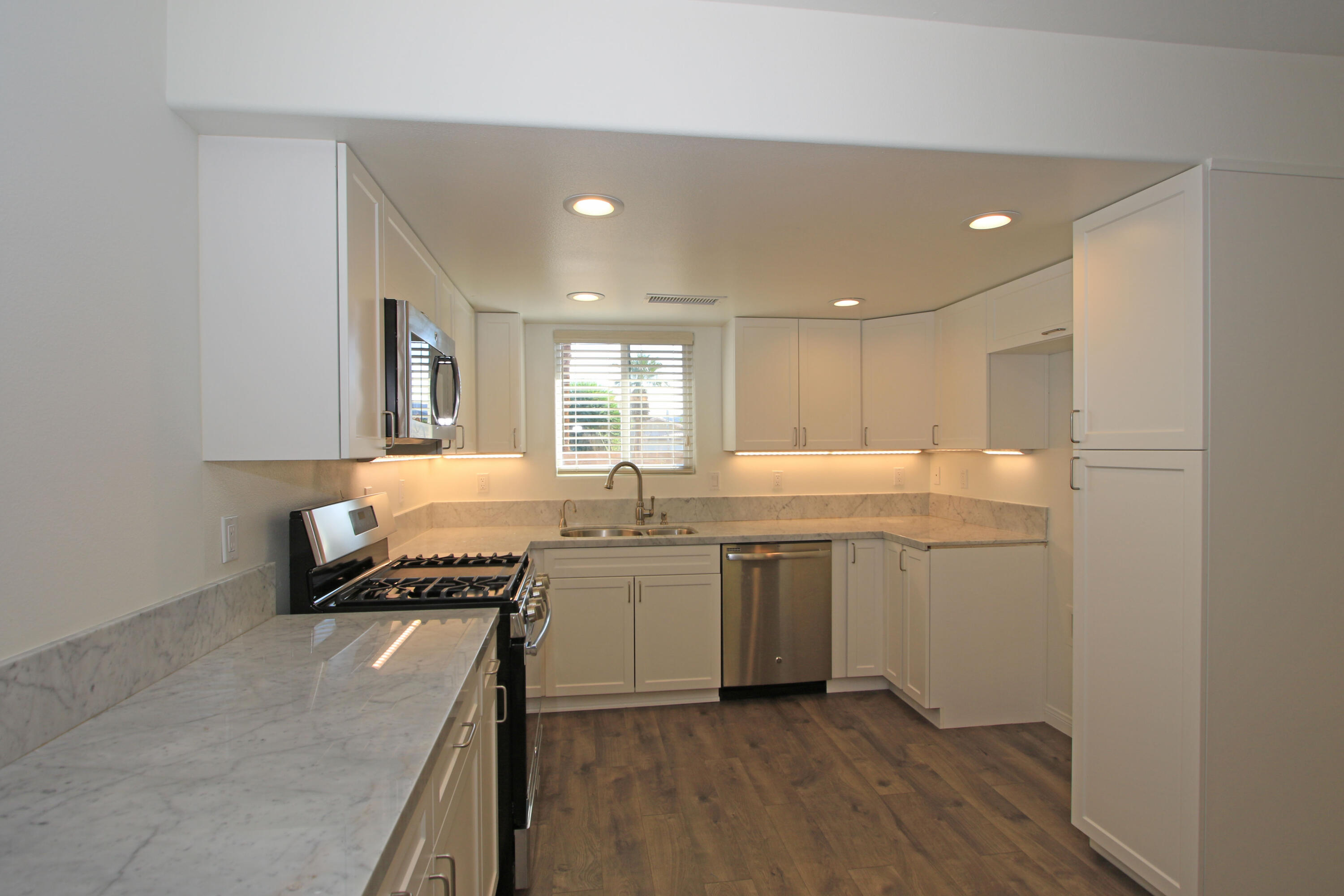 51845 Eisenhower Drive La Quinta, CA 92253 - Photo 12 of 35 a kitchen with a sink and cabinets