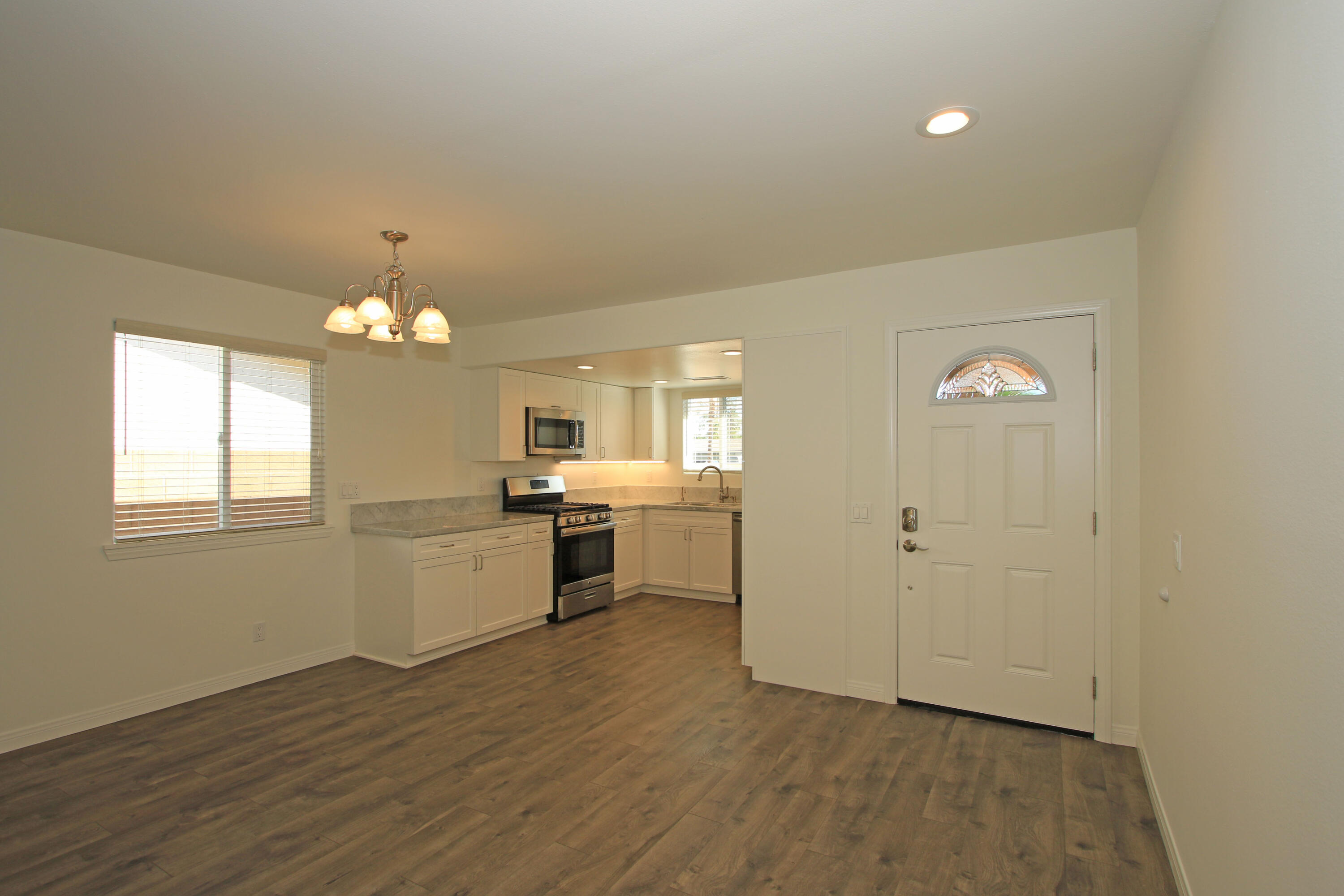 51845 Eisenhower Drive La Quinta, CA 92253 - Photo 15 of 35 a view of a kitchen with a sink cabinets and wooden floor