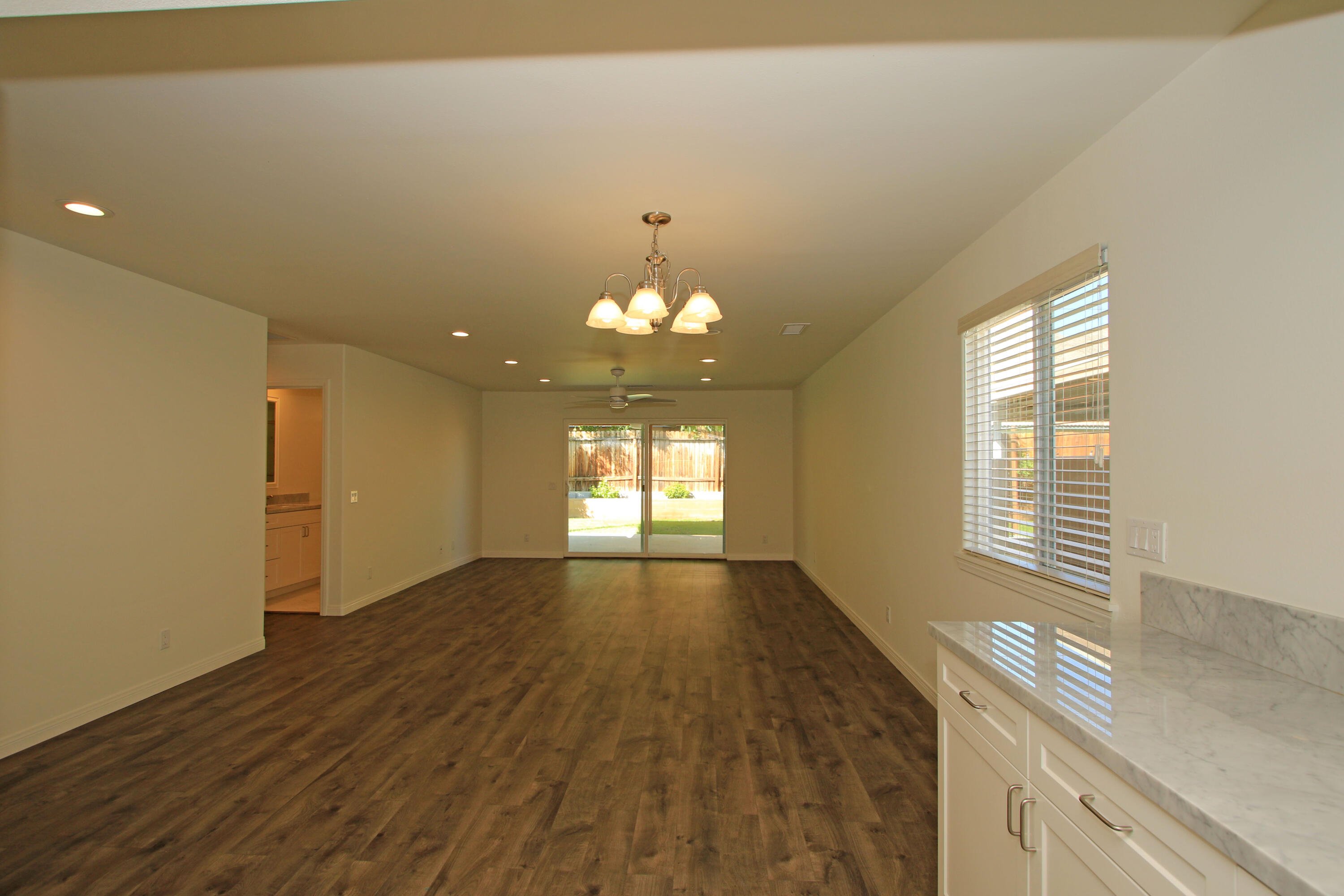51845 Eisenhower Drive La Quinta, CA 92253 - Photo 16 of 35 a view of an empty room with window and wooden floor