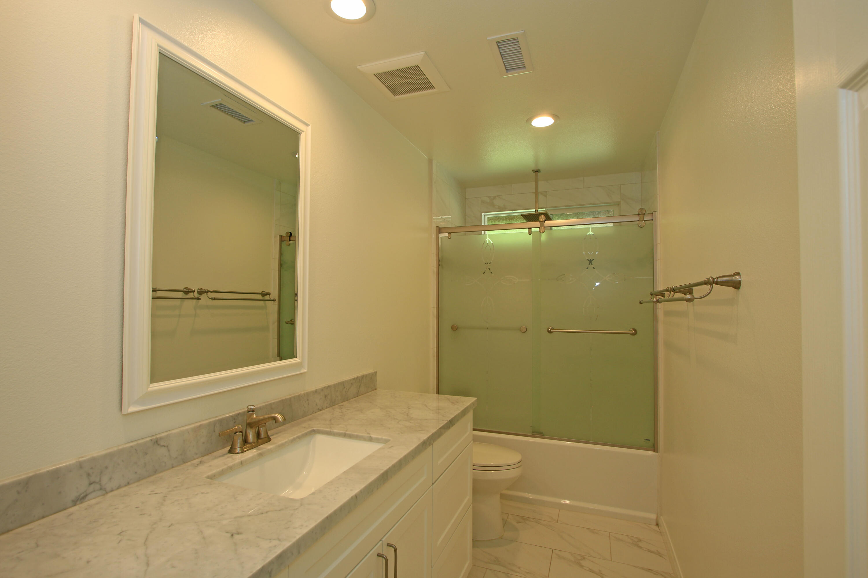 51845 Eisenhower Drive La Quinta, CA 92253 - Photo 19 of 35 a bathroom with a granite countertop sink toilet and shower