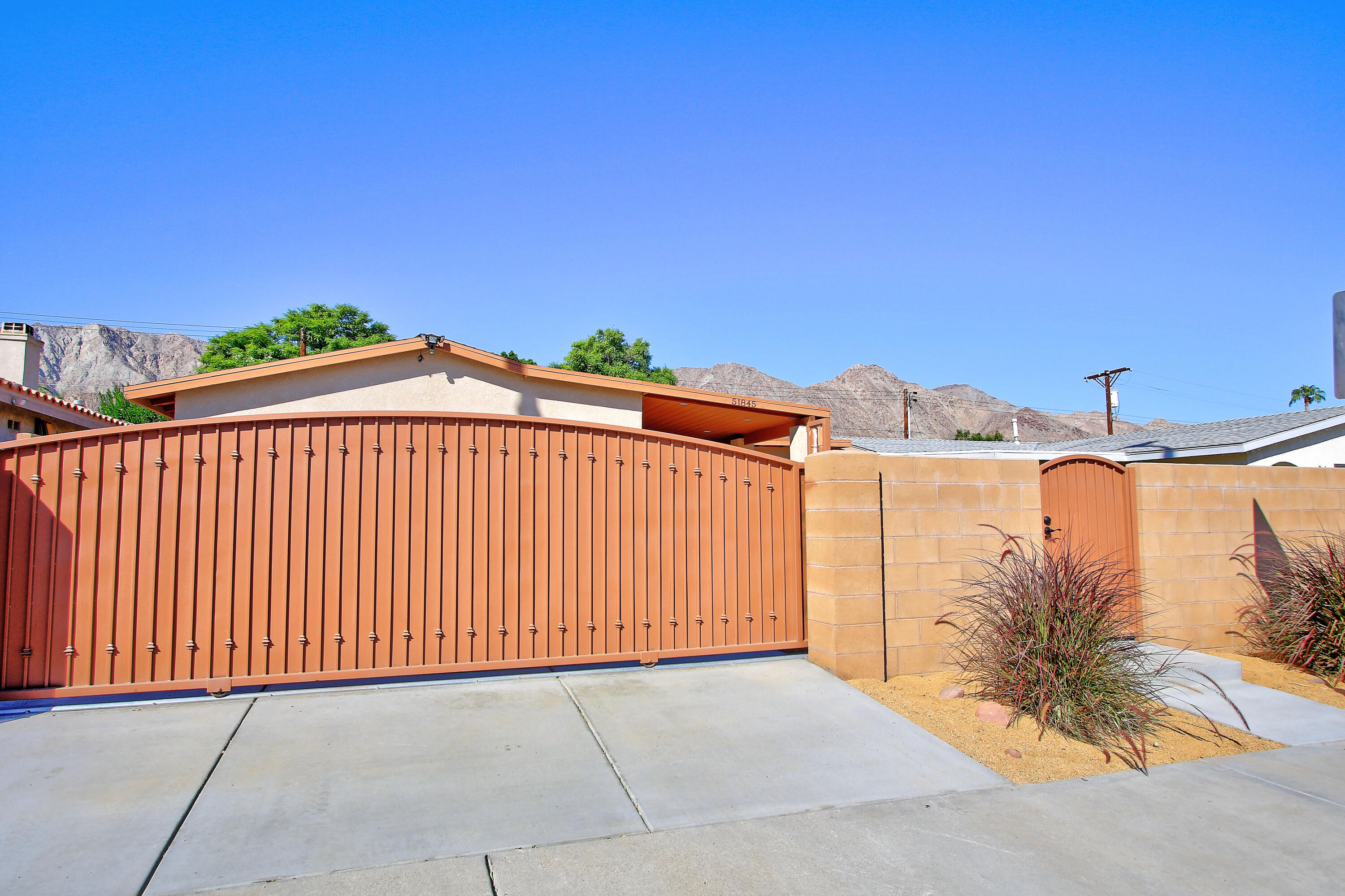 51845 Eisenhower Drive La Quinta, CA 92253 - Photo 2 of 35 a view of a white building with palm trees in front of it