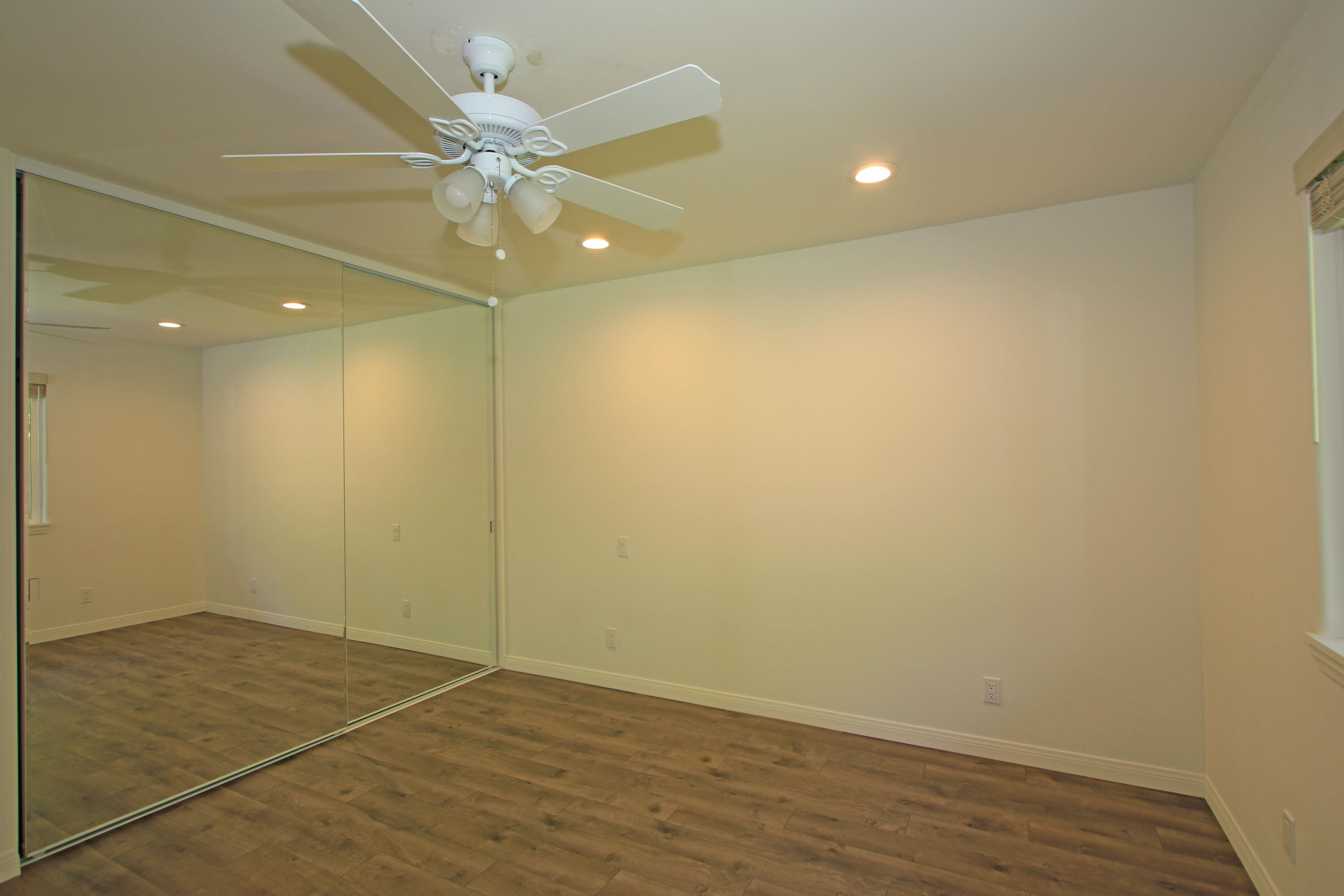 51845 Eisenhower Drive La Quinta, CA 92253 - Photo 22 of 35 an empty room with a fan and a ceiling fan