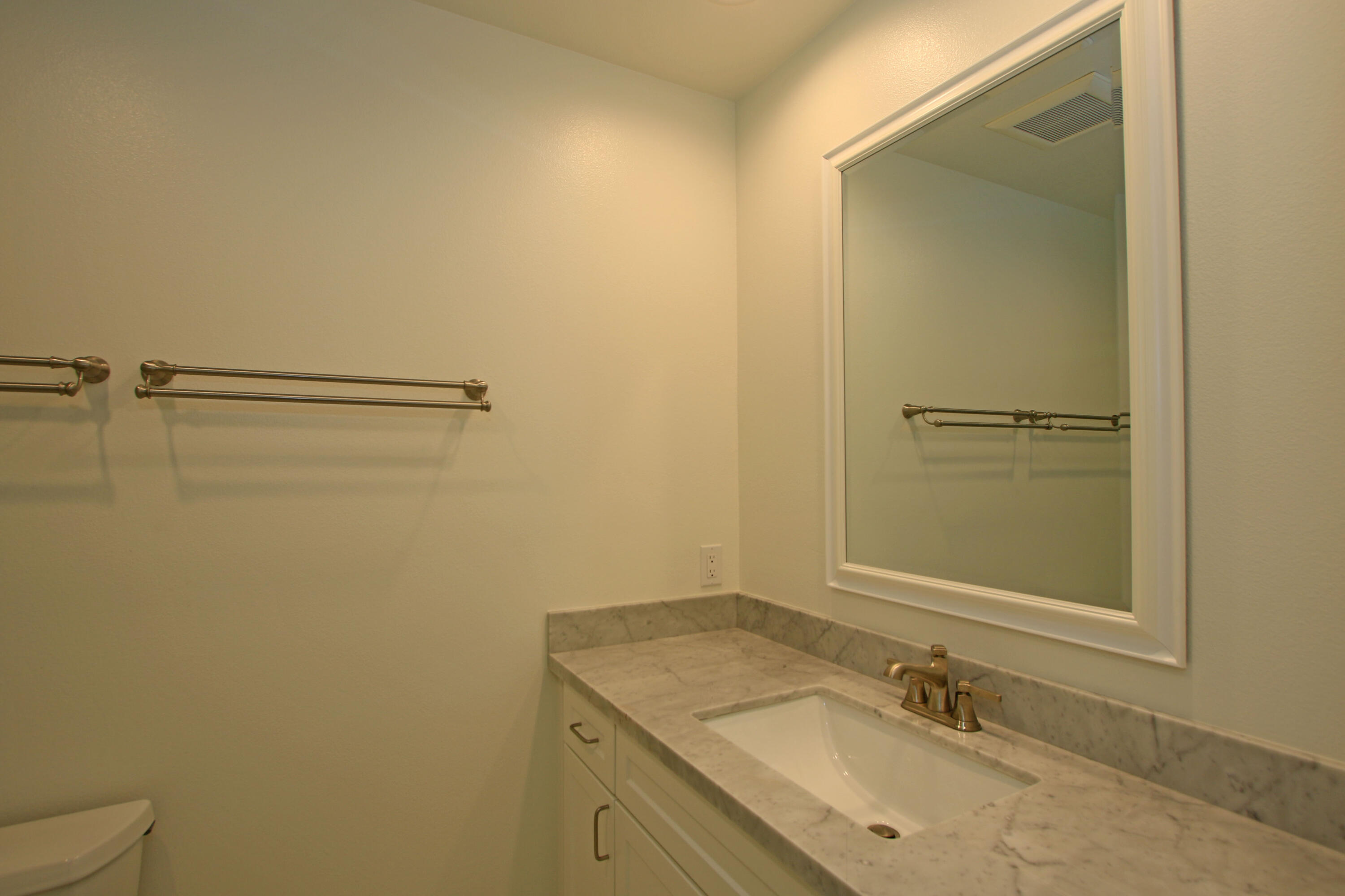 51845 Eisenhower Drive La Quinta, CA 92253 - Photo 23 of 35 a bathroom with a granite countertop sink and a mirror