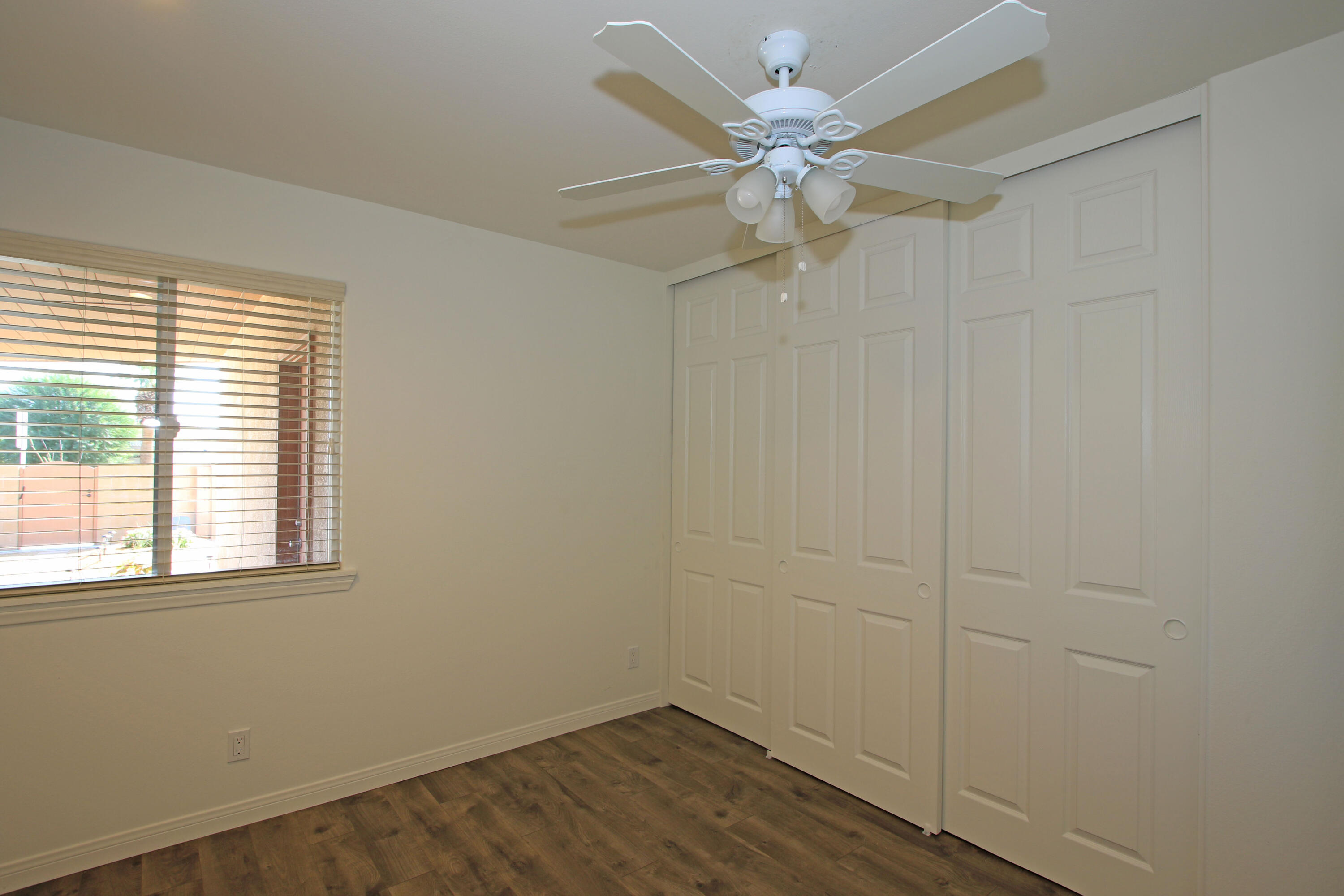 51845 Eisenhower Drive La Quinta, CA 92253 - Photo 25 of 35 an empty room with a window and a fan