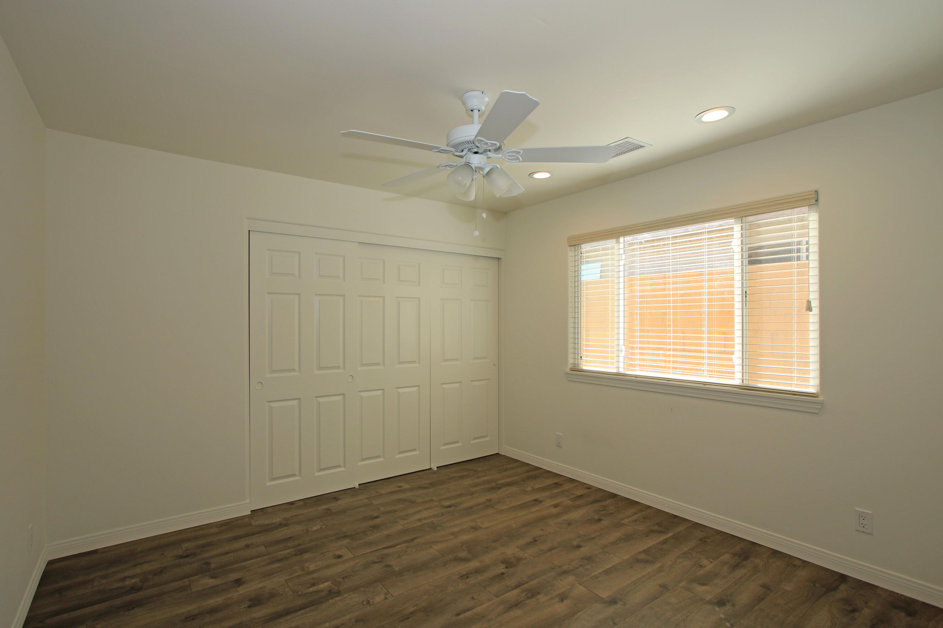 51845 Eisenhower Drive La Quinta, CA 92253 - Photo 26 of 35 an empty room with a window and a ceiling fan