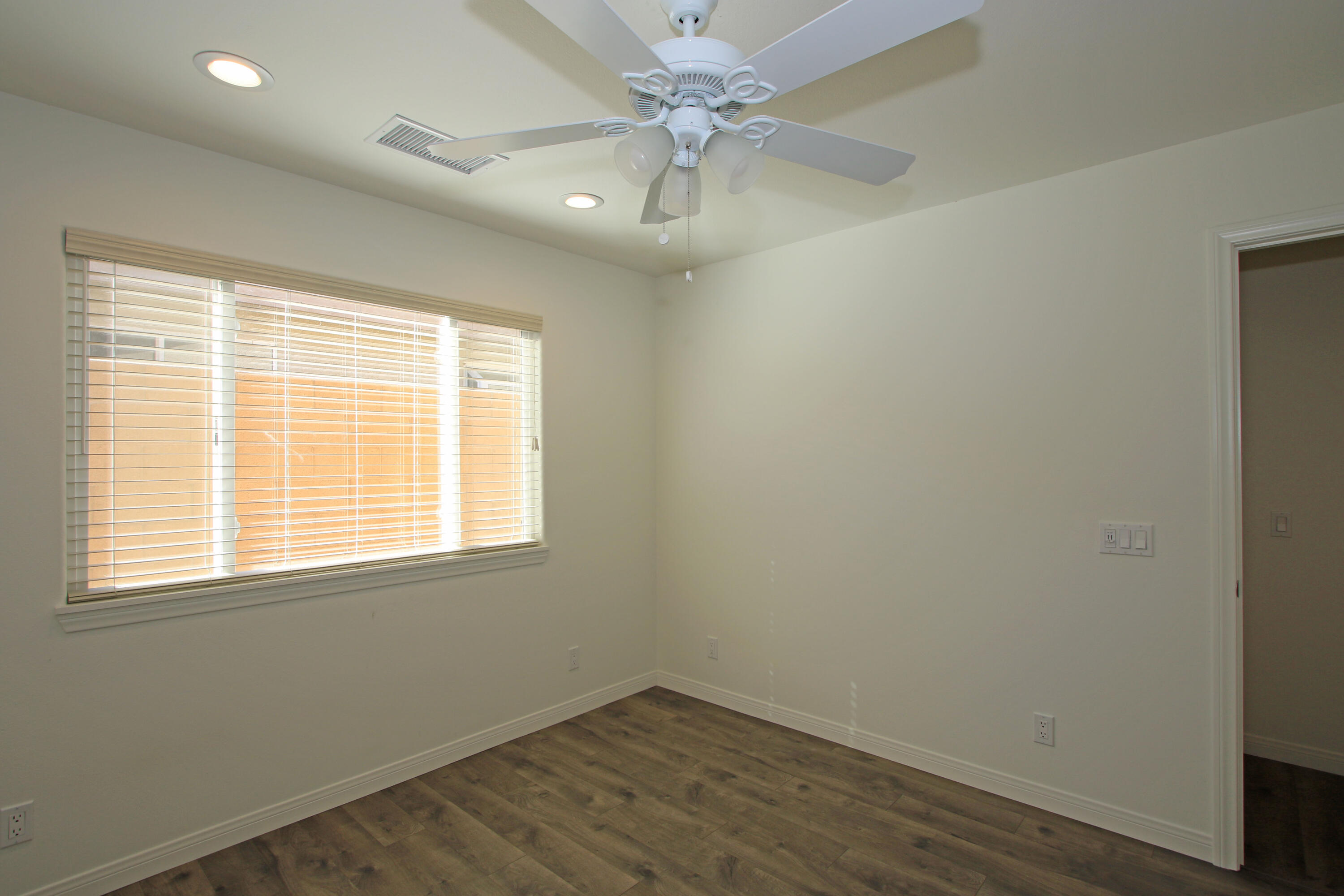 51845 Eisenhower Drive La Quinta, CA 92253 - Photo 27 of 35 an empty room with a window and a fan