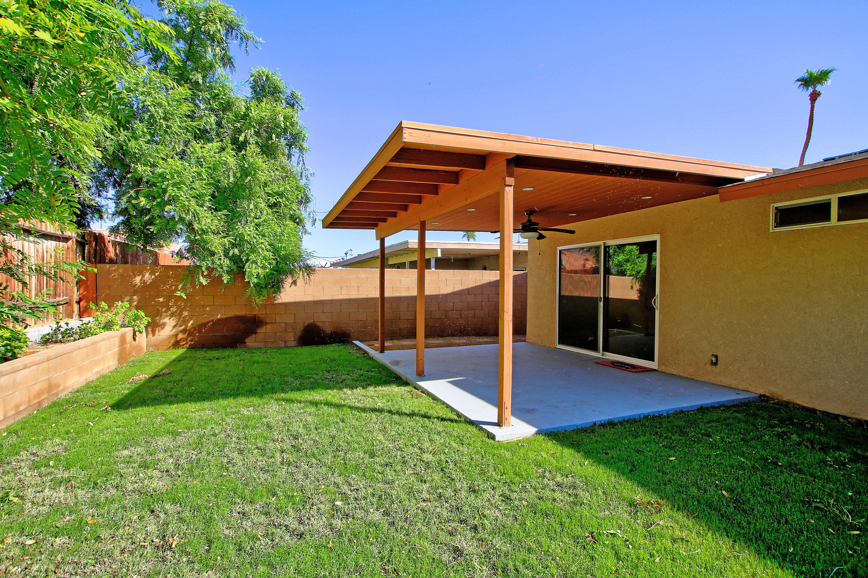 51845 Eisenhower Drive La Quinta, CA 92253 - Photo 30 of 35 a view of an house with backyard and porch