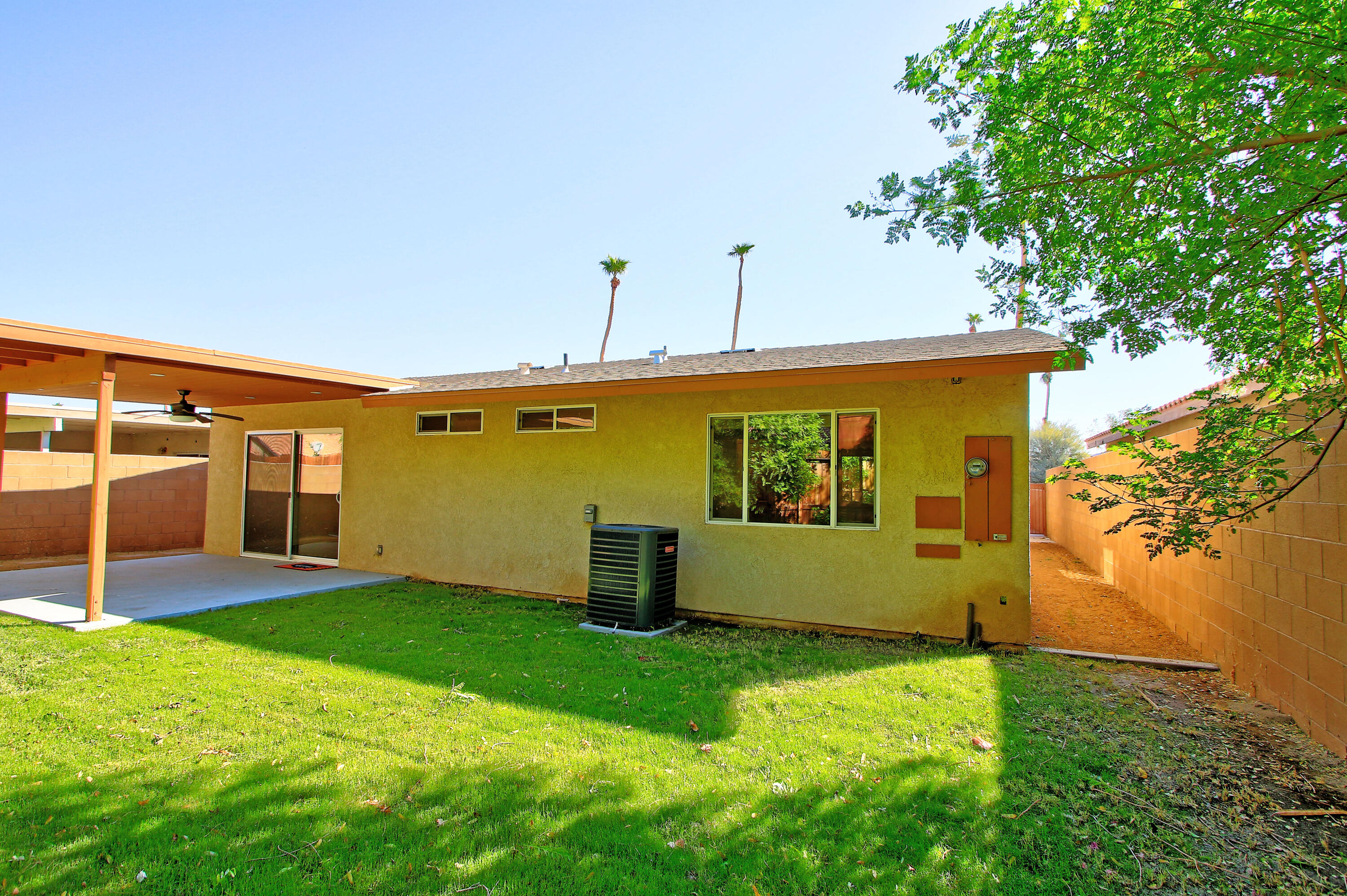 51845 Eisenhower Drive La Quinta, CA 92253 - Photo 31 of 35 a front view of a house with garden
