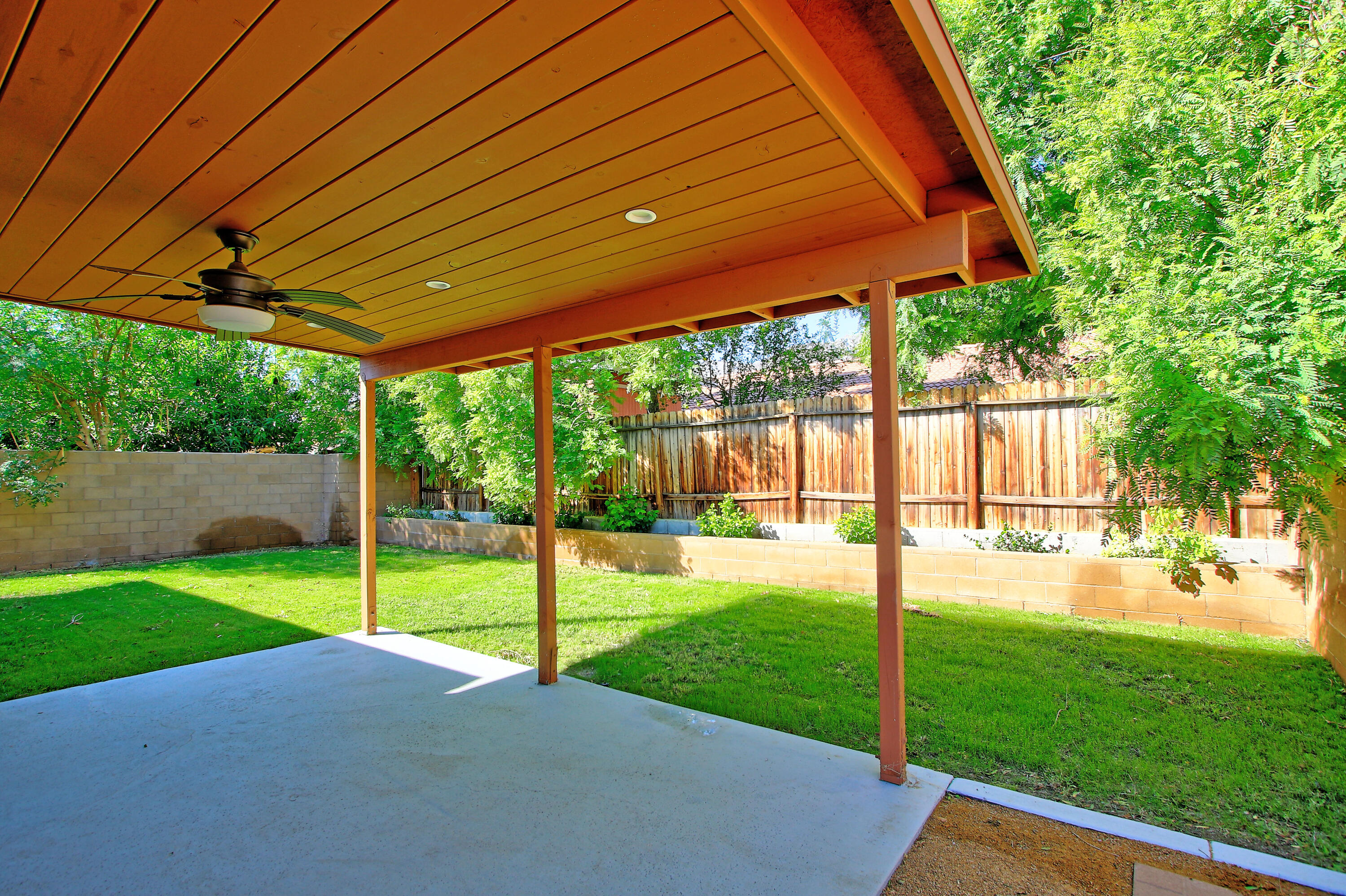 51845 Eisenhower Drive La Quinta, CA 92253 - Photo 34 of 35 a view of a backyard with table and chairs under an umbrella
