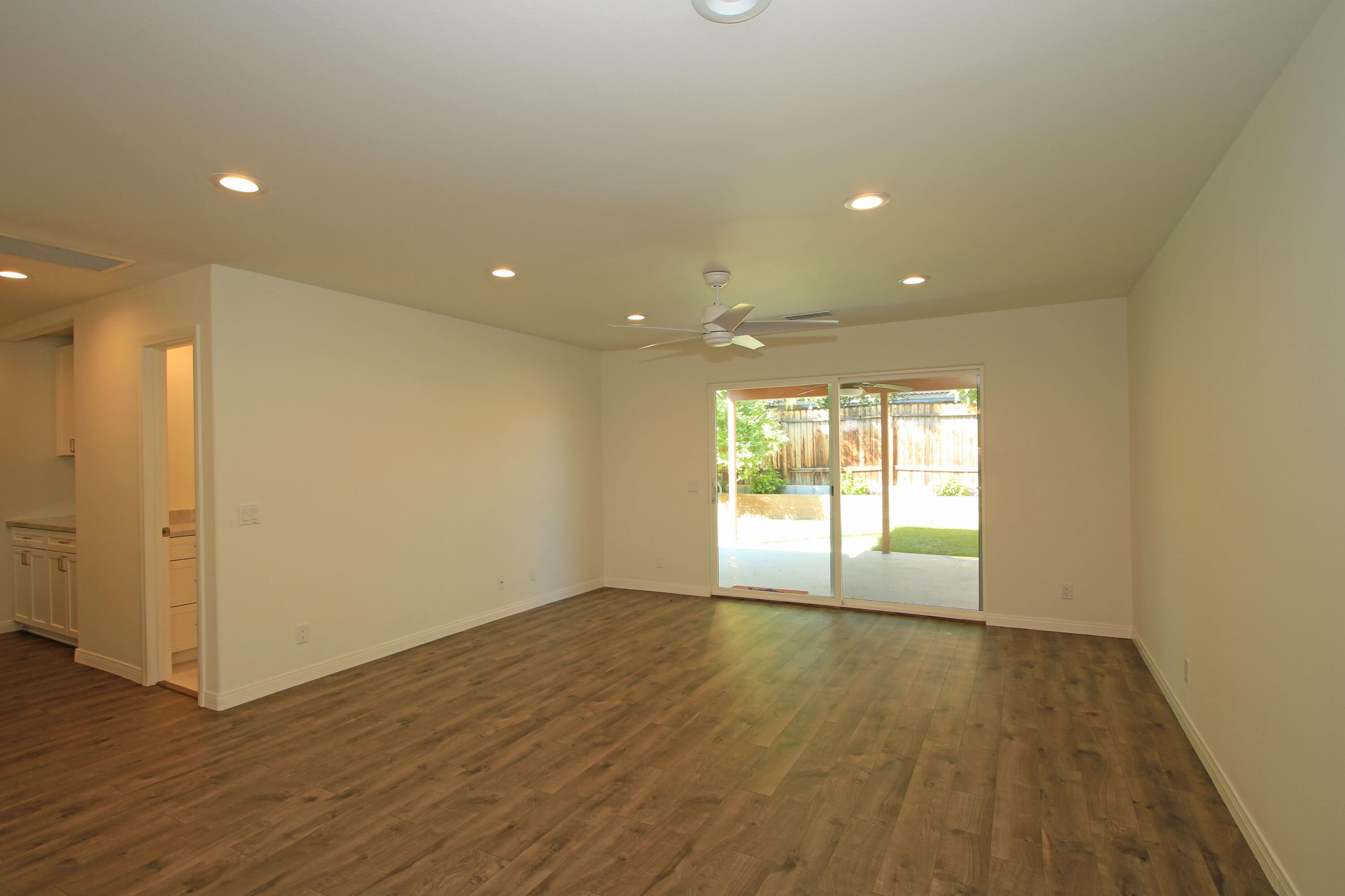51845 Eisenhower Drive La Quinta, CA 92253 - Photo 10 of 35 a view of an empty room with wooden floor and a window