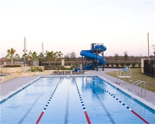 a view of a swimming pool with a lounge chair