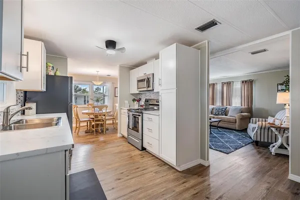 a kitchen with a refrigerator and a sink