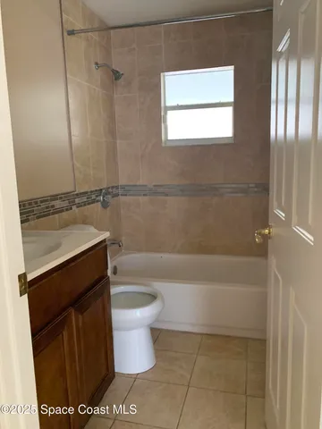 a bathroom with a sink a toilet and bathtub