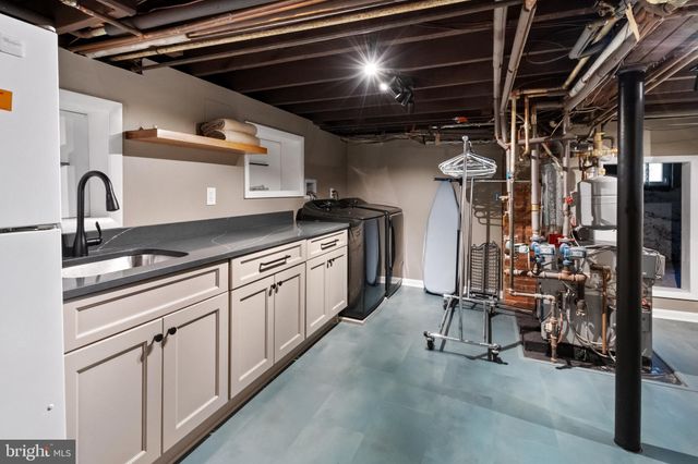 a kitchen with white cabinets and white appliances