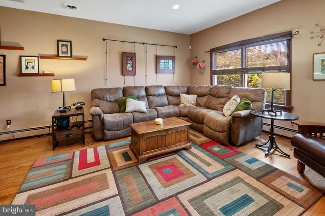 a living room with furniture a rug and a window