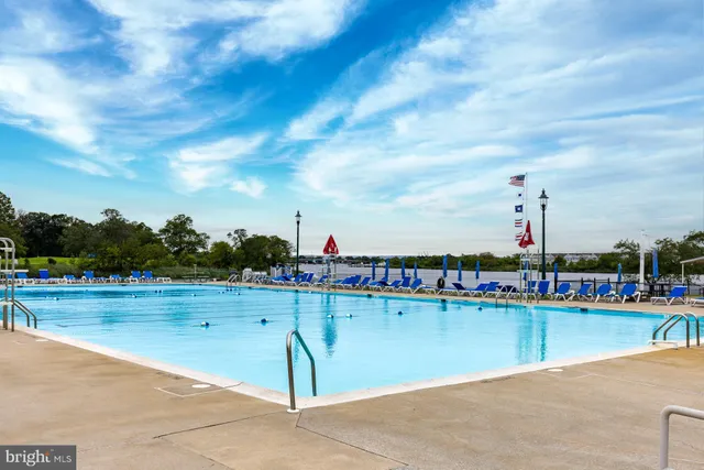 a view of a swimming pool with a lawn chairs