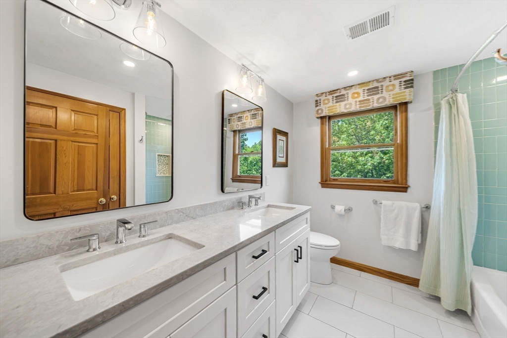 83 Jefferson Road Franklin, MA 02038 - Photo 19 of 34 a bathroom with a double vanity sink a mirror and a bathtub