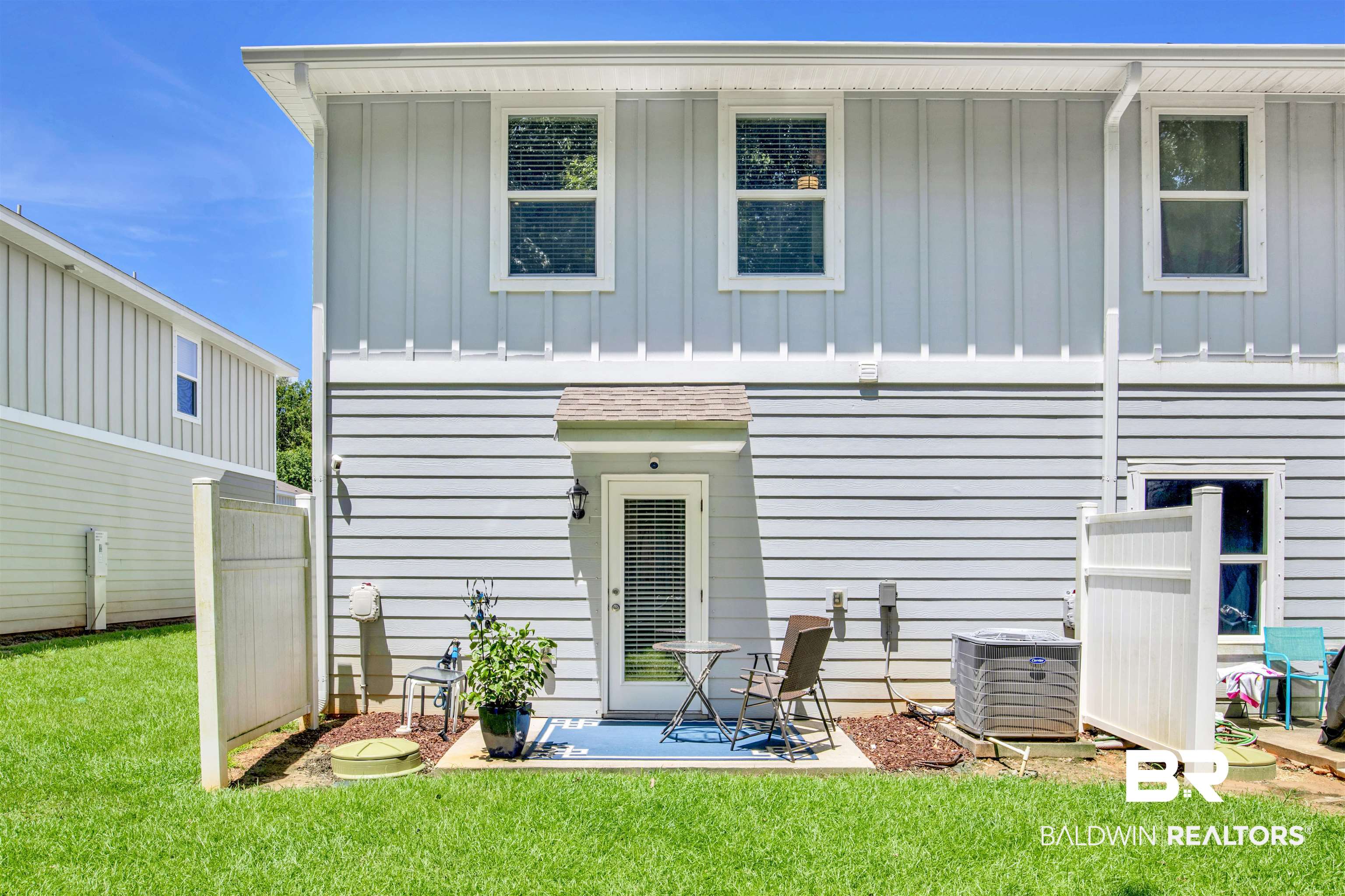 25806 Pollard Road, Unit 20 Daphne, AL 36526 - Photo 25 of 29 Back of property featuring a lawn and central AC unit