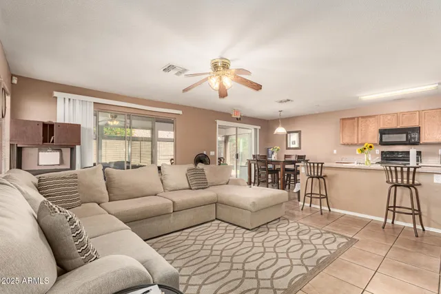 a living room with furniture and kitchen view