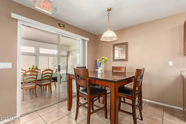 a dining room with furniture a chandelier and a rug
