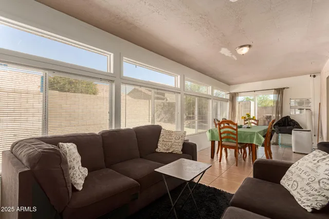 a living room with furniture and large windows