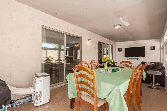 a view of a dining room with furniture and a flat screen tv