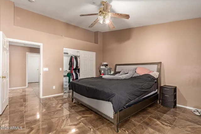 a bedroom with a bed and a chandelier