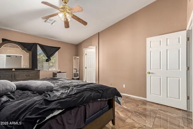 a bedroom with a bed and a chandelier